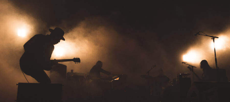 some musicians on stage in a hazy, smoky environment