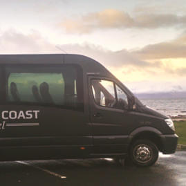 Coast to Coast Travel 18 seater mini-coach parked at the coast
